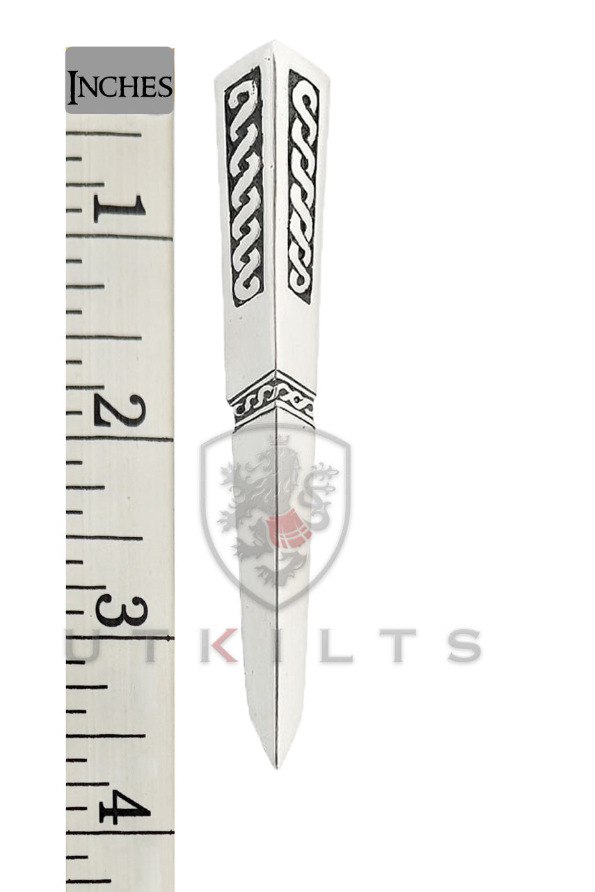 A silver knife featuring intricate Celtic designs