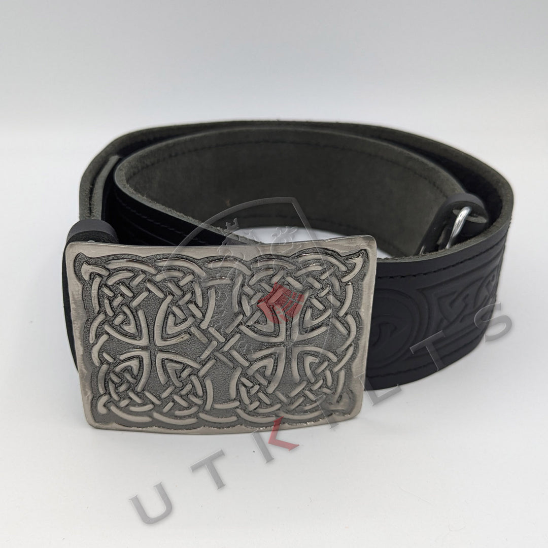 A traditional black leather belt featuring an intricate Celtic design, complemented by a classic buckle.