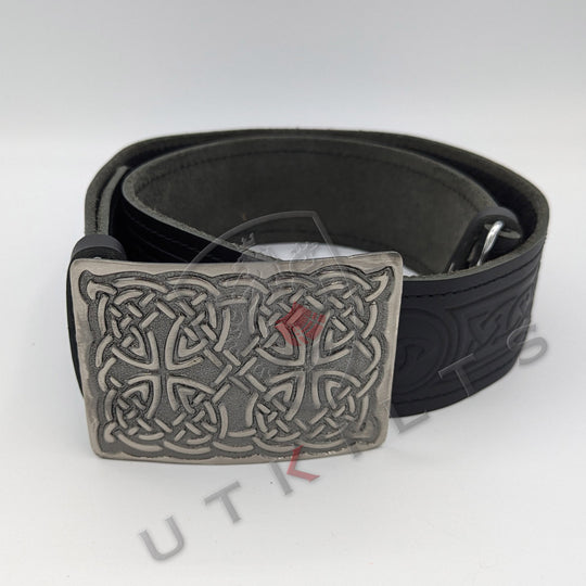 A traditional black leather belt featuring an intricate Celtic design, complemented by a classic buckle.