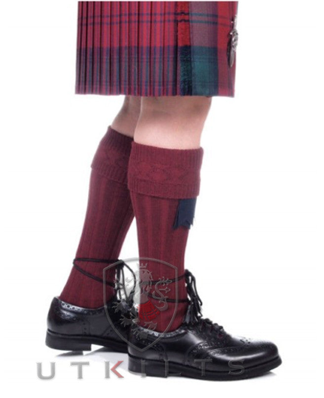 A man in a kilt paired with Premium Burgundy Kilt Hose and black shoes