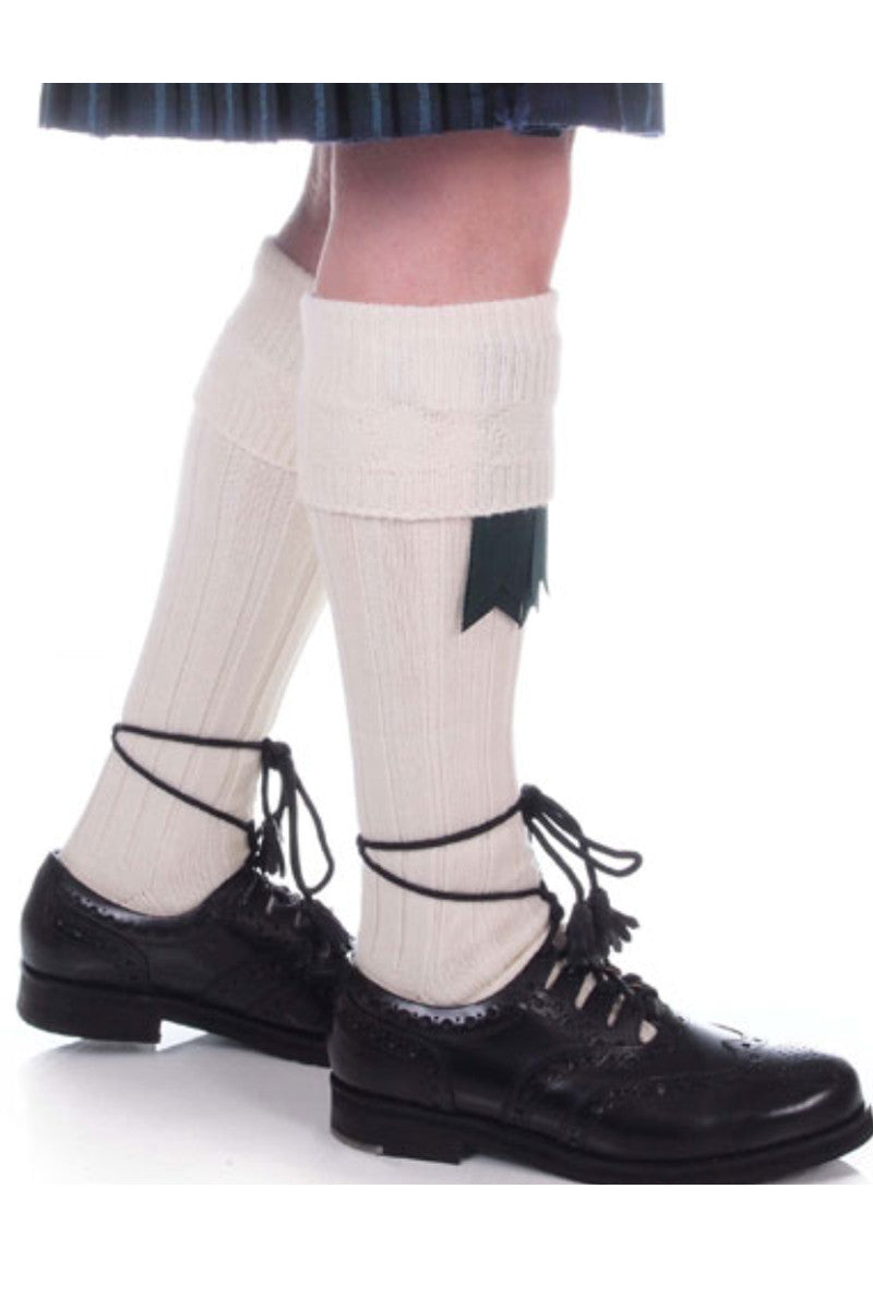 A man in a kilt paired with Premium Cream Kilt Hose  and black shoes.