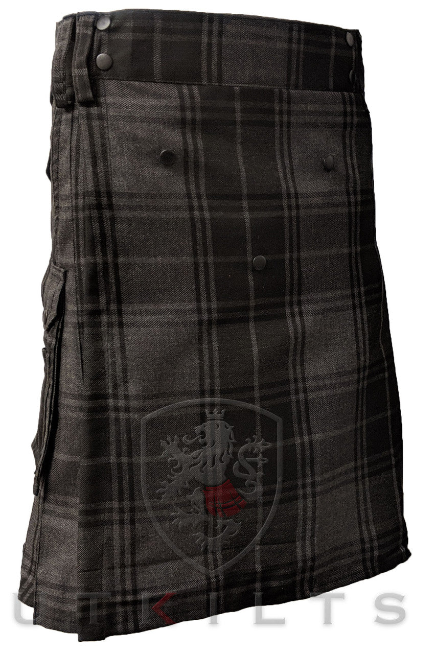 A black and grey tartan kilt featuring a crest, designed for comfort with a utility style for the Ultimate Highlander experience.