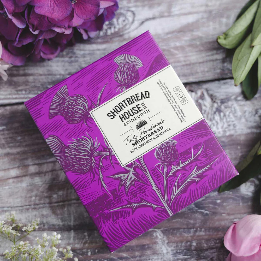 A purple soap box adorned with delicate floral designs, showcasing an elegant and vibrant packaging.