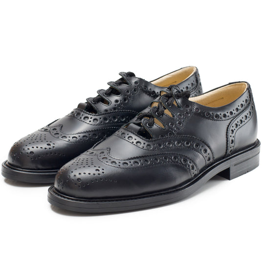 Classic black leather brogue oxford shoe with decorative perforations, exemplifying timeless craftsmanship and style.