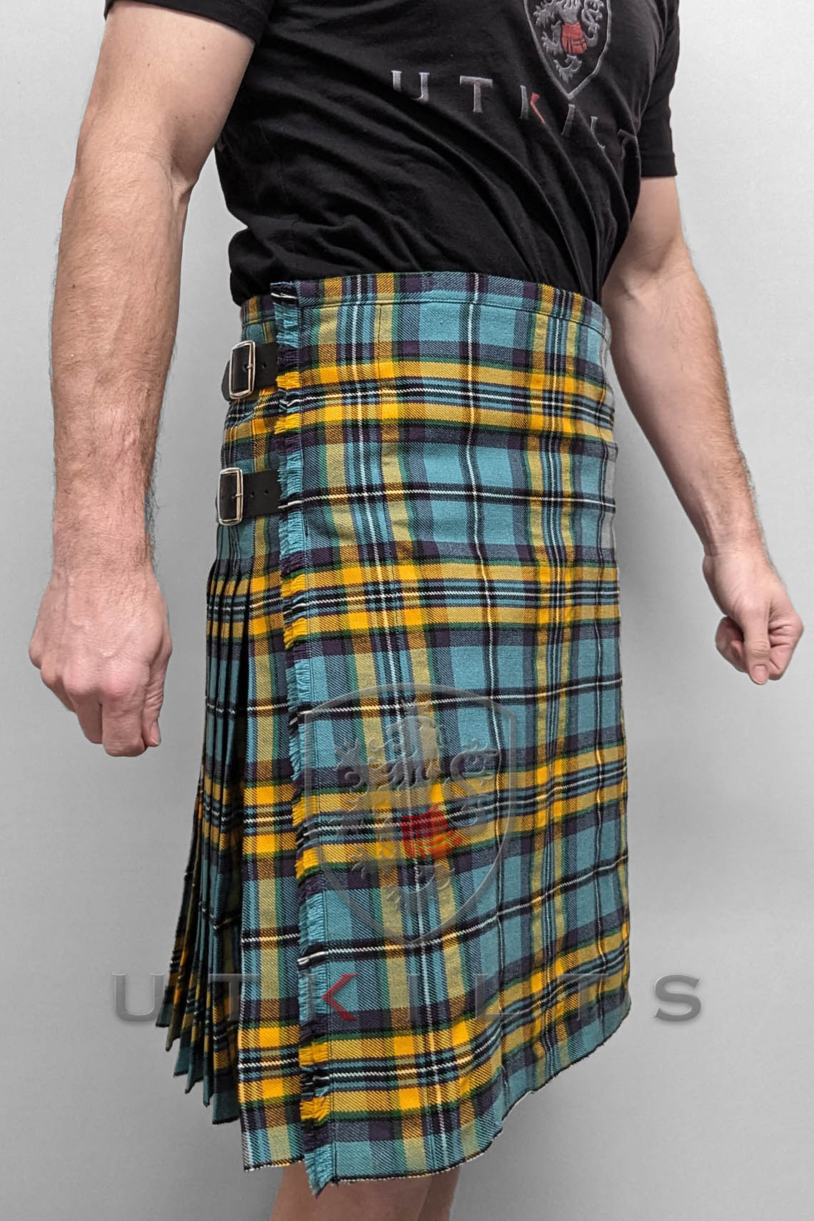 A man in a blue and yellow tartan kilt exemplifies traditional Scottish fashion, crafted from premium wool for quality.