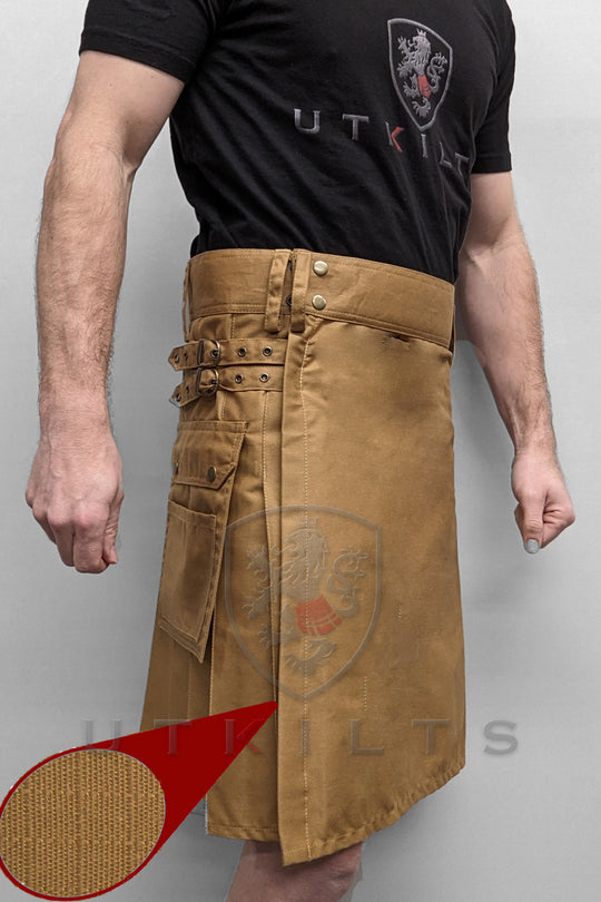  man is dressed in a tan kilt equipped with pockets, highlighting a unique fashion choice that emphasizes comfort and utility.