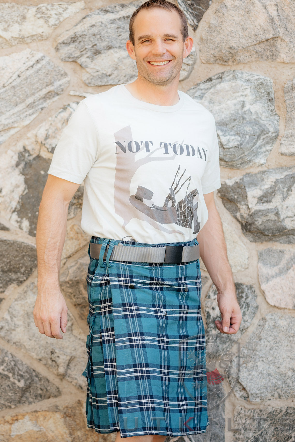 A man dressed in a kilt paired with a casual t-shirt.