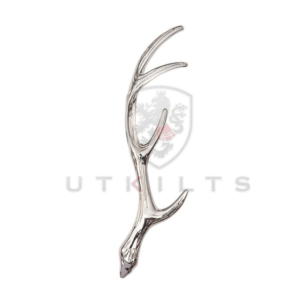 A polished silver antler kilt pin featuring a striking red and white logo, showcasing elegance and craftsmanship.