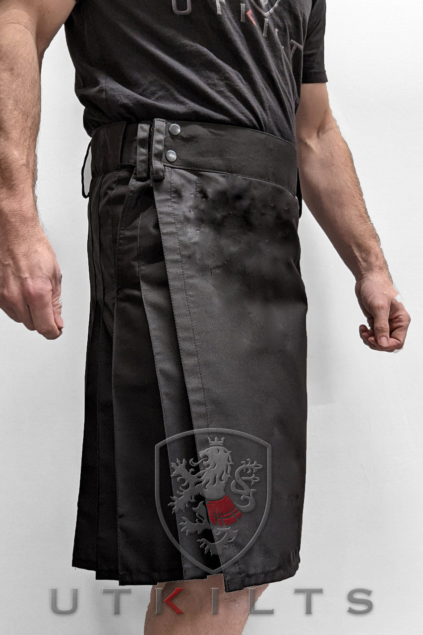  man models a black kilt adorned with a vibrant red dragon, representing a blend of tradition and modern fashion.