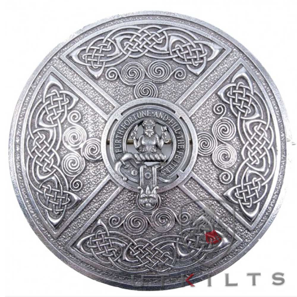 A Celtic shield featuring intricate knotwork and a dragon, representing a premium Scottish clan crest brooch.