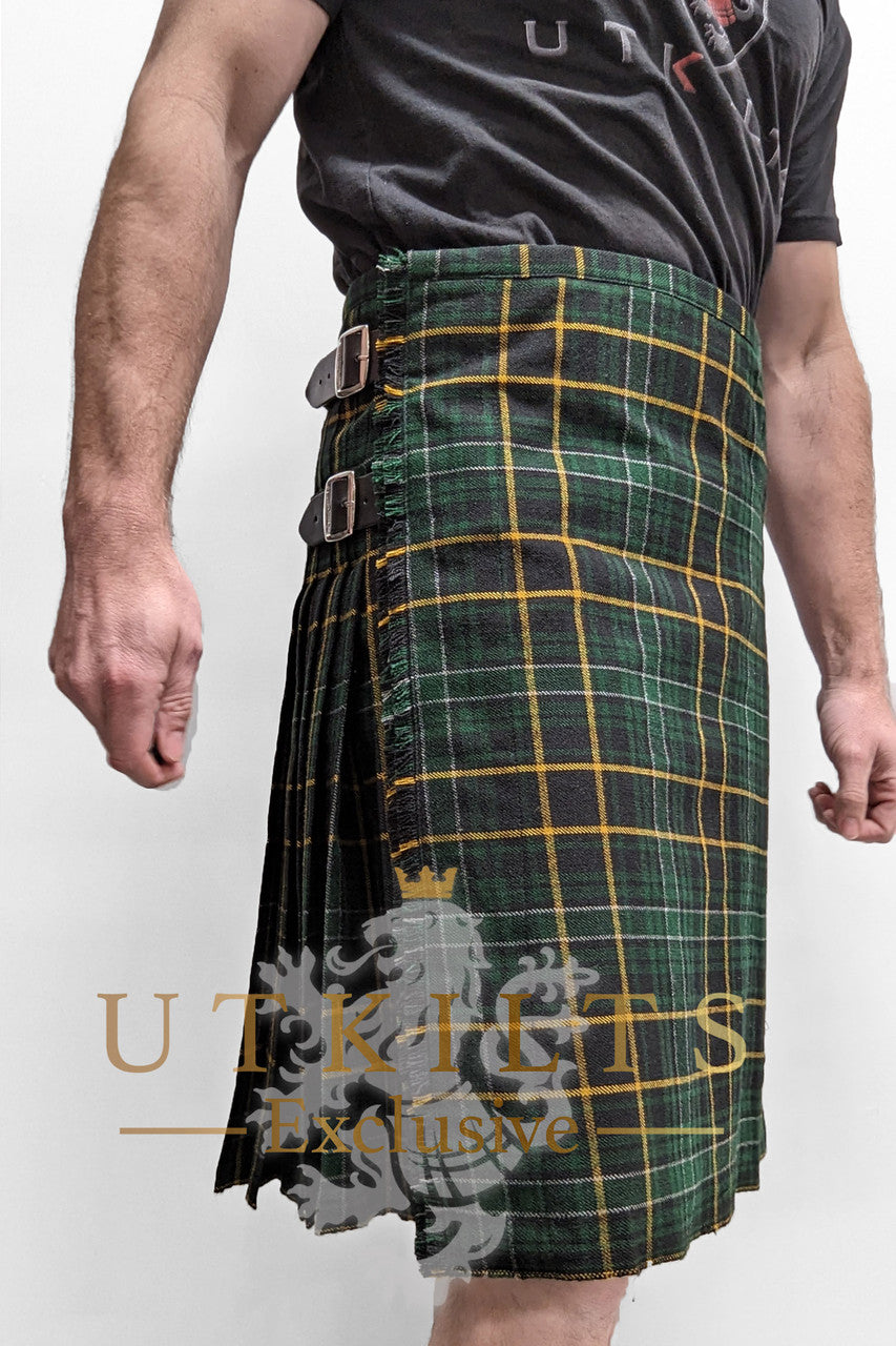 A man dons a vibrant green and yellow tartan kilt, exemplifying the exclusive designs from UTK Exclusives.