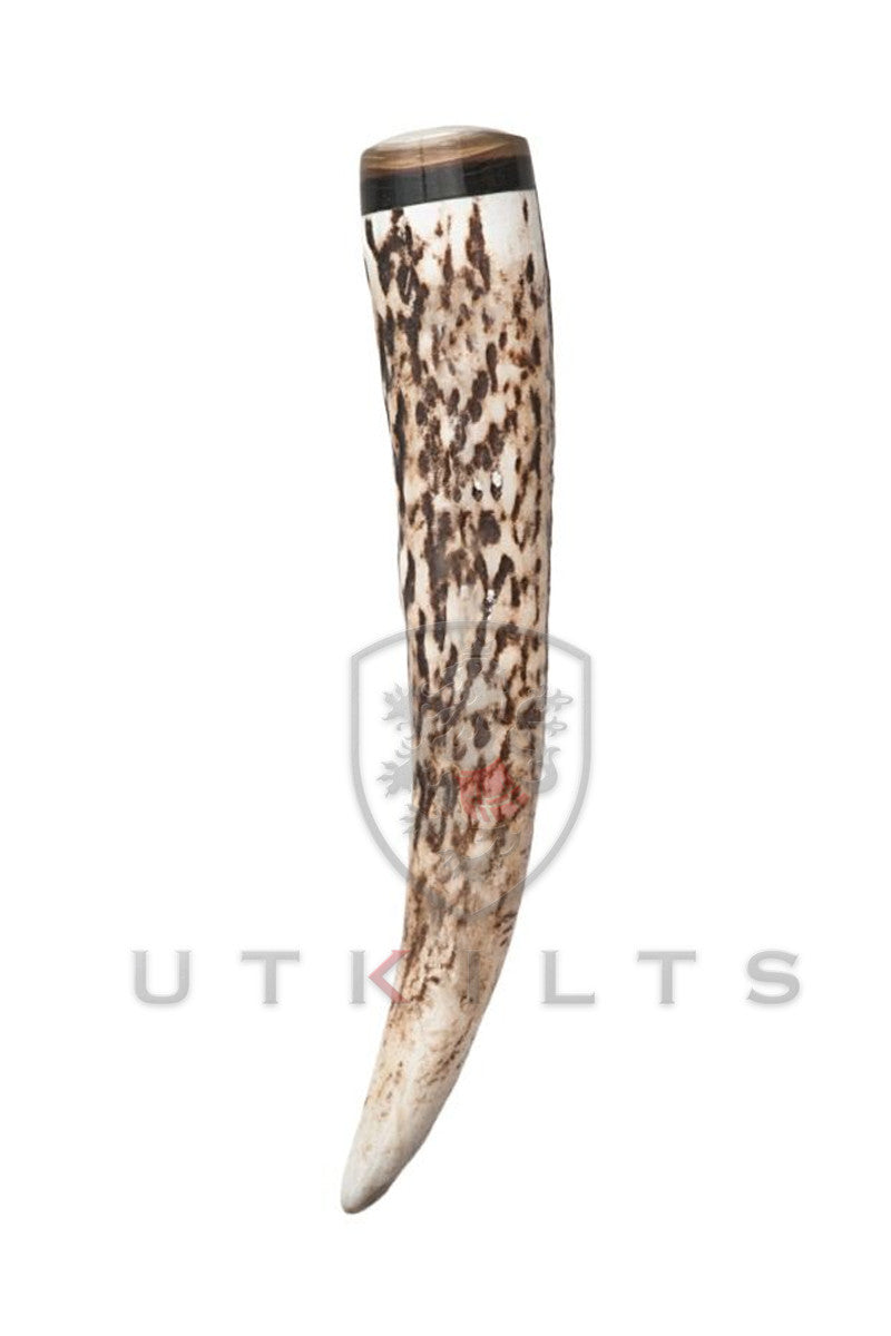 A premium stag horn kilt pin featuring a large horn adorned with an elegant black and white pattern.
