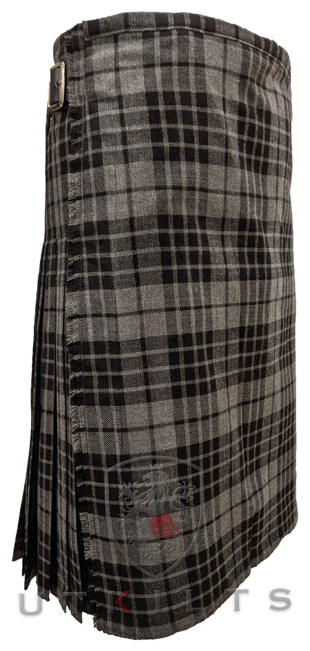 A traditional wool tartan kilt in black and white, displayed from the front with a prominent silver buckle accent.
